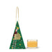 A green triangular box with a Christmas tree design and a gold handle, next to a small glass candle holder with a lit candle inside.