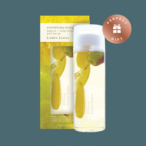a bottle of Linden Leaves body oil and a box of the product, both with a yellow and green color scheme.
