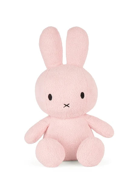 A pink stuffed bunny toy with large ears and a small nose.