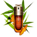 a bottle of Clarins Double Serum Hydericlic-Topical System, surrounded by green leaves and orange pieces.