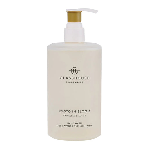 A bottle of hand wash with a pump dispenser, labeled as "KOTO IN BLOOM CAMELLIA & LOSUS".