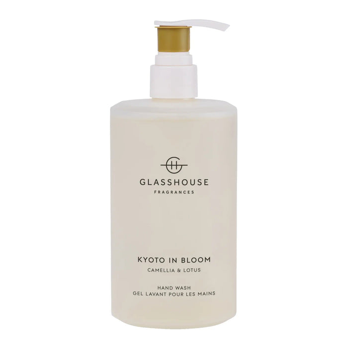 A bottle of hand wash with a pump dispenser, labeled as "KOTO IN BLOOM CAMELLIA & LOSUS".