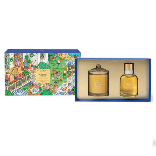 two perfume bottles, one larger and one smaller, placed in a blue box with a colorful illustration of people and a garden scene.