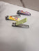 Three colorful nail clippers with cartoon animal designs are placed on a white surface.
