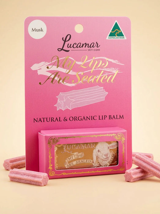 a pink packaging for a lip balm product called "My Lips Are Seated" by Lucamar, which is a natural and organic lip balm.
