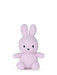 A small, pink stuffed bunny toy is sitting on a white background.