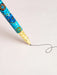 A close-up view of a pen with a colorful, patterned design on its body, with a black ink line being drawn on a plain white background.