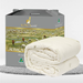 a gray cardboard box with a picture of a herd of sheep on it, and a white blanket folded on top of the box.