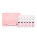 a pink box containing six identical bottles of a product, likely a skincare product, with a clear plastic bottle in front of the box.
