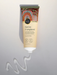 A tube of "Native Frangipani" hand cream with a colorful, decorative label, placed on a white background.