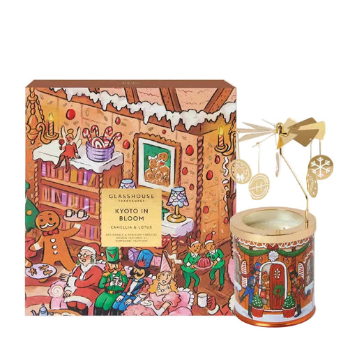 a gingerbread house-themed candle and a box with a gingerbread house illustration.