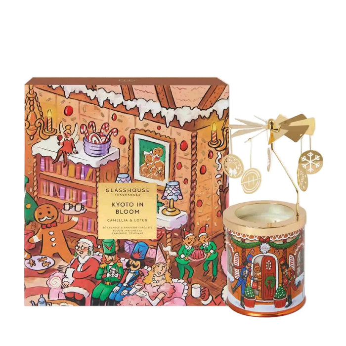 a gingerbread house-themed candle and a box with a gingerbread house illustration.