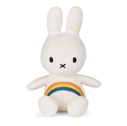 A white plush toy rabbit with a rainbow patch on its belly.
