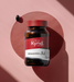 A bottle of Astaxanthin A1 supplement against a pink background.