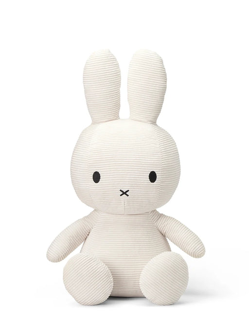 A white stuffed rabbit toy with black eyes and a black x on its face.