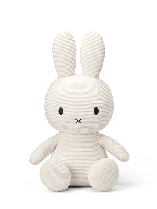 A white stuffed rabbit toy with black eyes and a black x on its face.