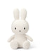 A white stuffed rabbit toy with black eyes and a black x on its face.