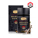 a bottle of Comvita Manuka Honey and its packaging, both of which are black with floral designs.