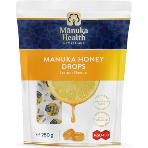 a package of Manuka Honey Drops, a product from the New Zealand company Manuka Health. The package features a lemon slice and a drop of honey, indicating the flavor of the product.