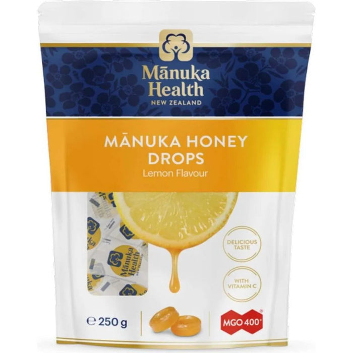 a package of Manuka Honey Drops, a product from the New Zealand company Manuka Health. The package features a lemon slice and a drop of honey, indicating the flavor of the product.