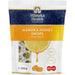 a package of Manuka Honey Drops, a product from the New Zealand company Manuka Health. The package features a lemon slice and a drop of honey, indicating the flavor of the product.