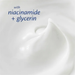 The image is a close-up of a white, creamy substance, possibly a lotion or cream, with a text overlay that reads "with niacinamide + glycerin".
