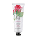 A tube of hand cream with a rose and pomegranate design.
