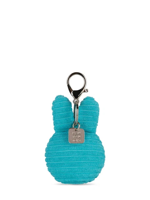 A turquoise-colored keychain with a silver metal clasp and a small tag attached to it.