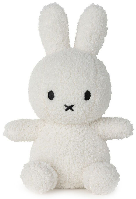 A white stuffed bunny toy with black eyes and a black mouth.