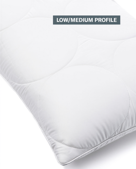 A pillow with a low/medium profile design, featuring a white, quilted pattern.
