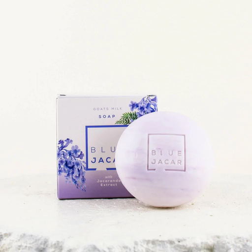 a soap bar and its packaging, both with a purple and white color scheme.