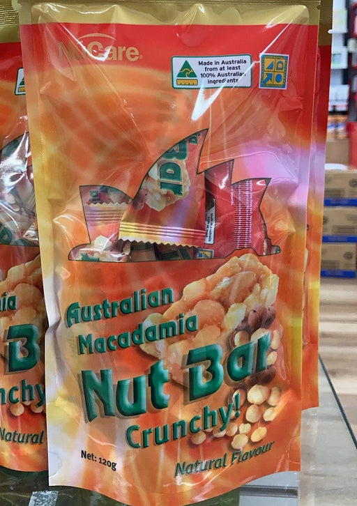 A bag of Australian Macadamia Nut Bar crunchy snacks is displayed on a shelf.