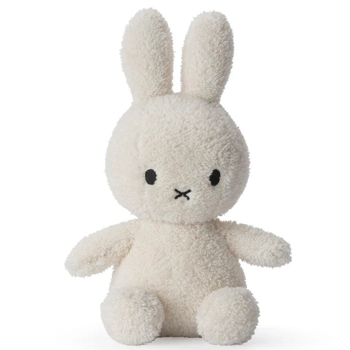A white stuffed bunny toy with black eyes and a black x on its face.