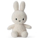 A white stuffed bunny toy with black eyes and a black x on its face.