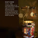 A decorative Christmas ornament with a spinning carousel and a festive candle accessory, placed on a table.