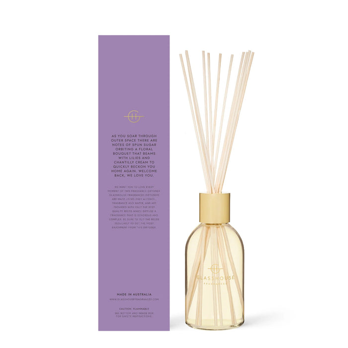 a glass house diffuser and its packaging, which is purple in color.
