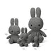 A group of three gray stuffed rabbits of different sizes, with the largest one being the tallest and the smallest being the shortest.