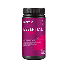 a bottle of melrose Essential Reds supplement, which is a pink-colored supplement with a black cap.