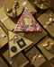 a collection of gift boxes and presents, some of which are wrapped in gold ribbons. The boxes appear to be gift-wrapped and contain various items, such as a small black box and a larger box with a colorful, illustrated design. The overall scene suggests a festive or holiday-themed setting, with the gift boxes and presents arranged in a visually appealing manner.