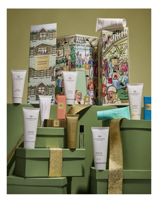 a collection of various skincare and beauty products, including tubes, jars, and bottles, arranged on a green surface. The products appear to be part of a gift set or a display, with some of them placed on top of green boxes. The image does not contain any text, and the focus is on the visual presentation of the products.