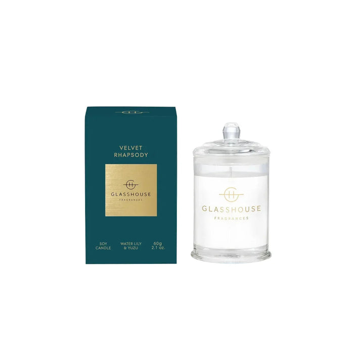 a green box and a clear glass jar with a gold label, both of which are labeled as "Velvet Rhapsody" candles from "GLASHOUSE Fragrances".
