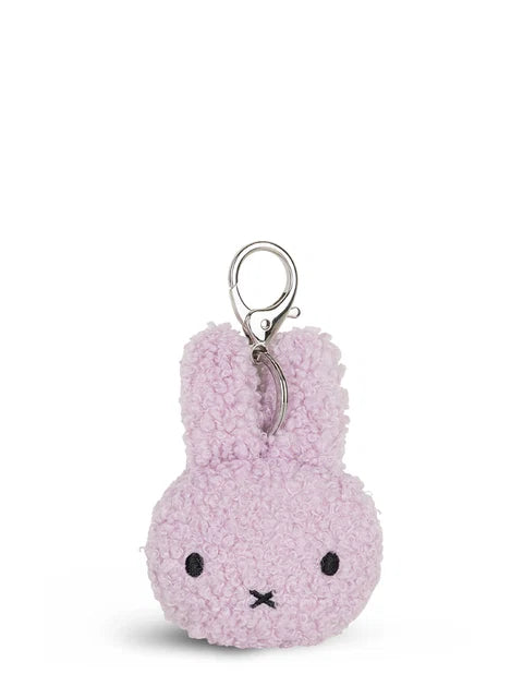 A small, plush keychain in a light purple color.