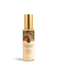 A bottle of Native Frangipani & Peach Blossom Scented Body Mist with Free Spirited Nurture with a gold cap.