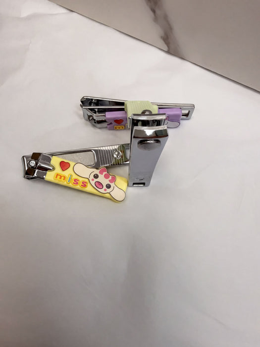 a pair of colorful nail clippers with a cartoon character design, placed on a white surface.