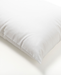 A white pillow with a smooth, unblemished surface.
