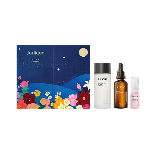 A collection of beauty products from the brand Jurlique, including a box, two bottles, and a small bottle, all featuring a night sky and floral designs.