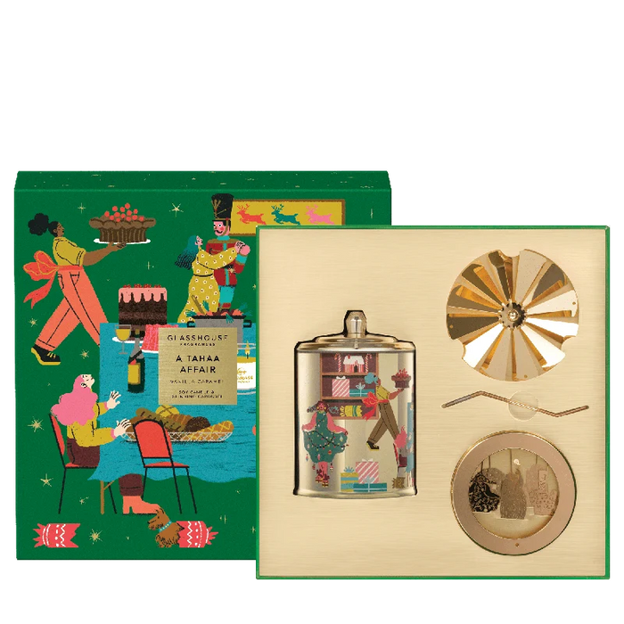 The image is a colorful illustration of a gift box with various objects, including a glass jar, a windmill, and a person sitting in a chair.
