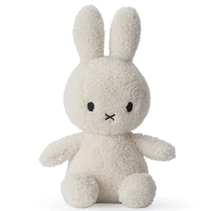 A white stuffed bunny toy with black eyes and a black x on its face.