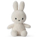 A white stuffed bunny toy with black eyes and a black x on its face.