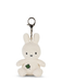 A white stuffed bunny toy with a green clover on its chest, hanging from a silver metal clip.
